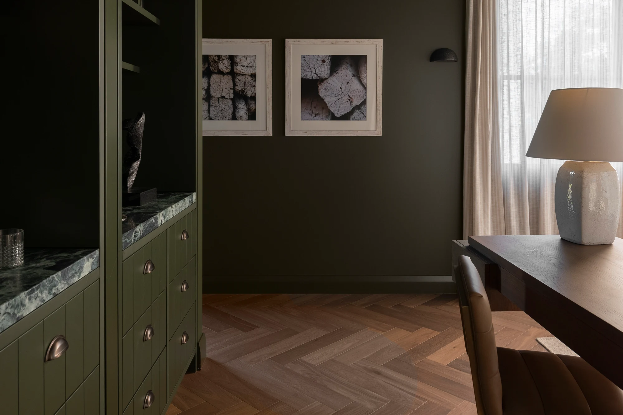 Fitted green joinery, stone shelving and timber flooring in a supplied project photograph.
